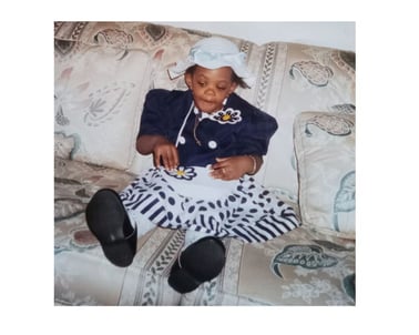 Angela as a child with stylish dress and matching pocketbook