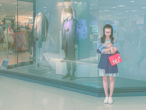 Girl Texting Outside Shopping Mall