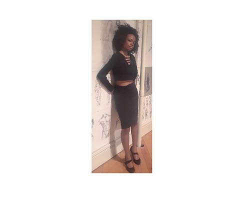 Angela wearing a bodycon skirt and crop sweater